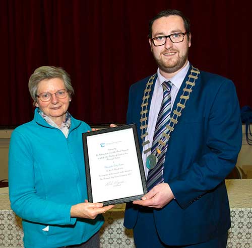 Cllr Mark Fitzgerald (right), Cathaoirleach, Carrick-on-Suir Municipal District, presenting Mary Clancy, Glengoole Tidy Towns, with their award for increased marks received in The National Tidy Towns Competition for Glengoole in 2021.